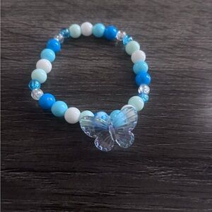 Blue and White Beaded Bracelet with Blue Butterfly Charm